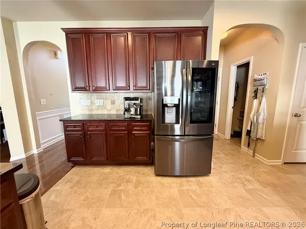 a kitchen with stainless steel appliances granite countertop a refrigerator stove and a sink