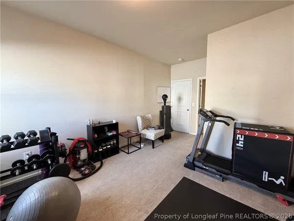 a bedroom with a bed and a chair