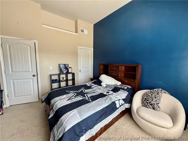 a bedroom with a bed and dresser