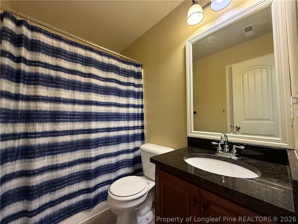 a bedroom with a bed and flat screen tv