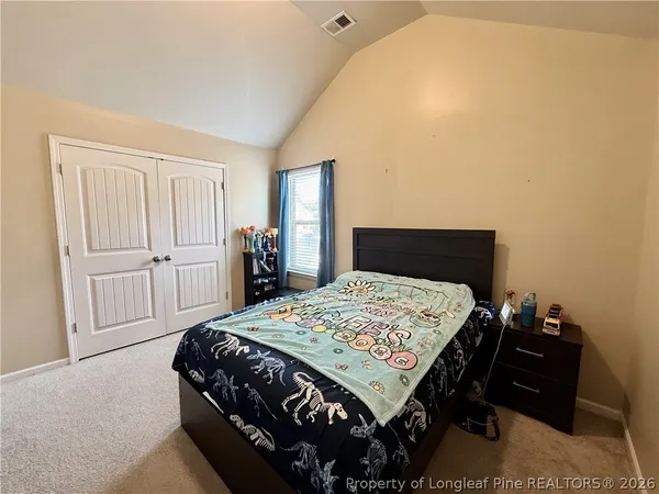 a bed room with furniture and a flat screen tv