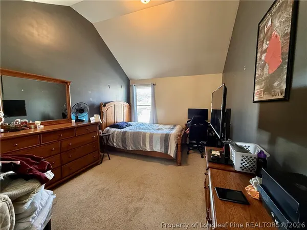 a bedroom with furniture and a window