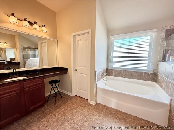 a bathroom with a tub and shower