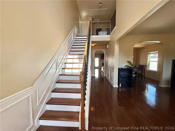 a view of entryway and hall with wooden floor