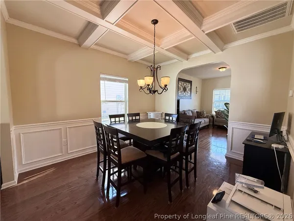 a view of a dining room with furniture and wooden floor