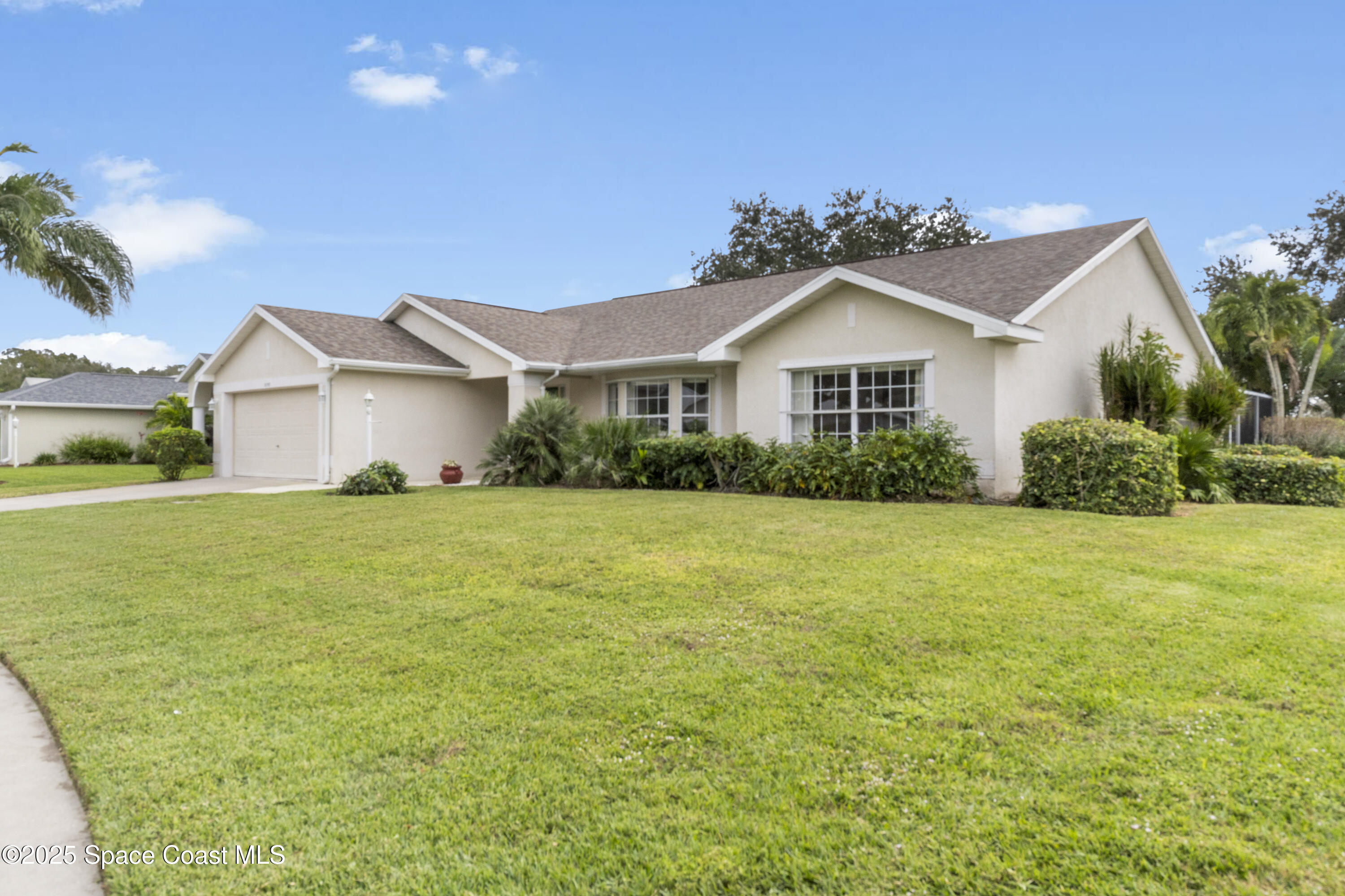 5155 3rd Manor Vero Beach, FL 32968 - Photo 1 of 29 a front view of a house with a garden