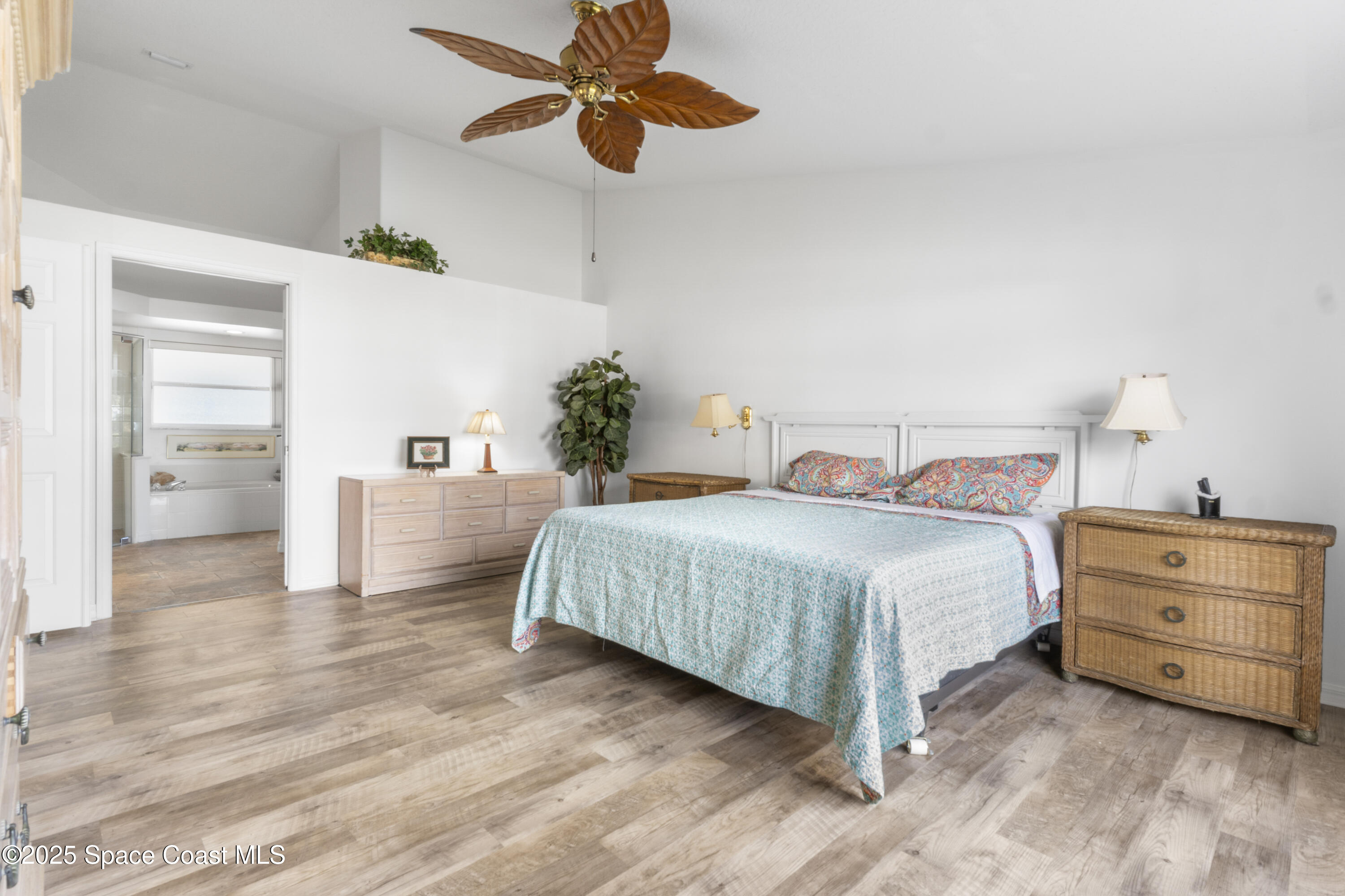 5155 3rd Manor Vero Beach, FL 32968 - Photo 16 of 29 a bedroom with a bed and a chandelier