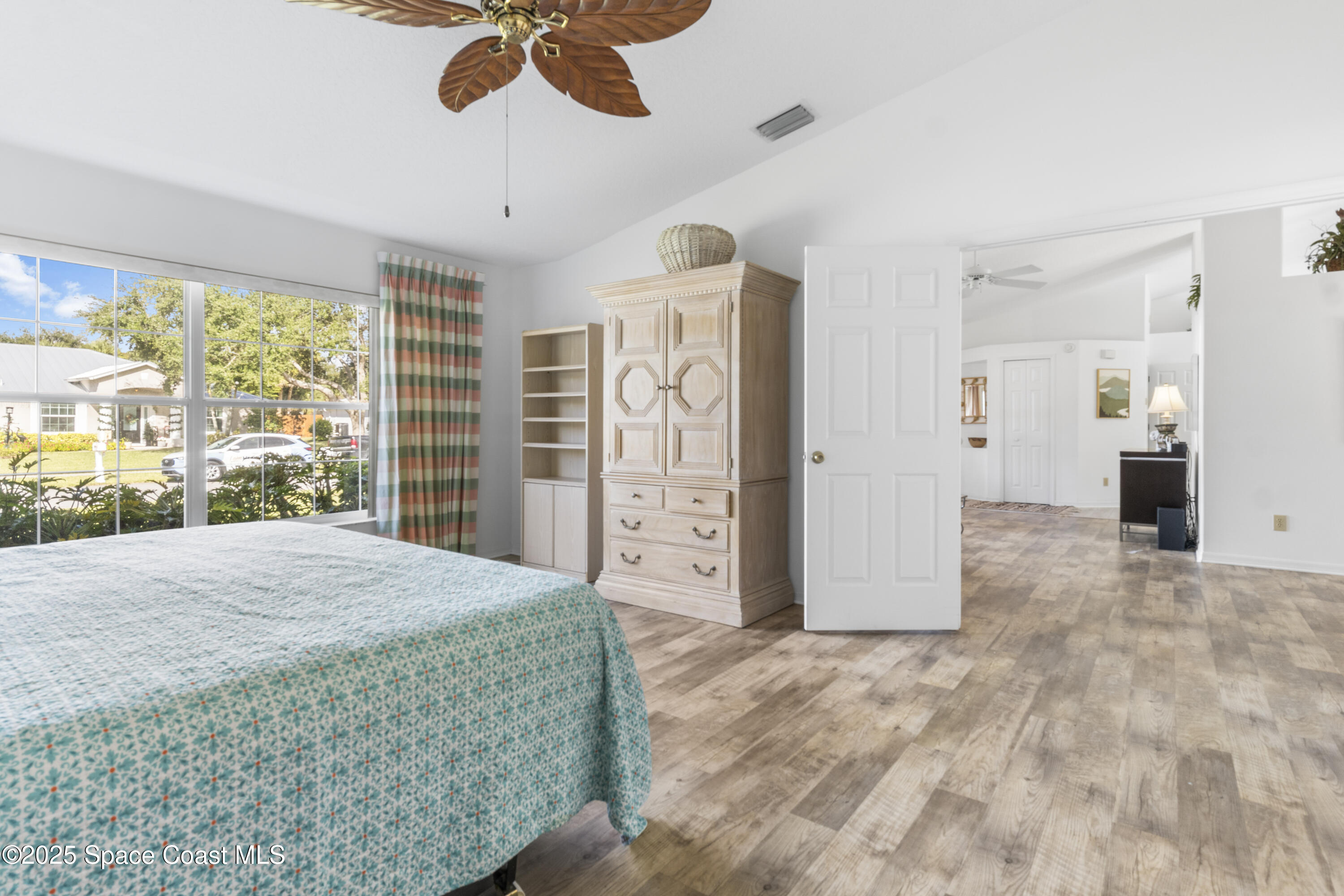 5155 3rd Manor Vero Beach, FL 32968 - Photo 17 of 29 a spacious bedroom with a large bed closet and window