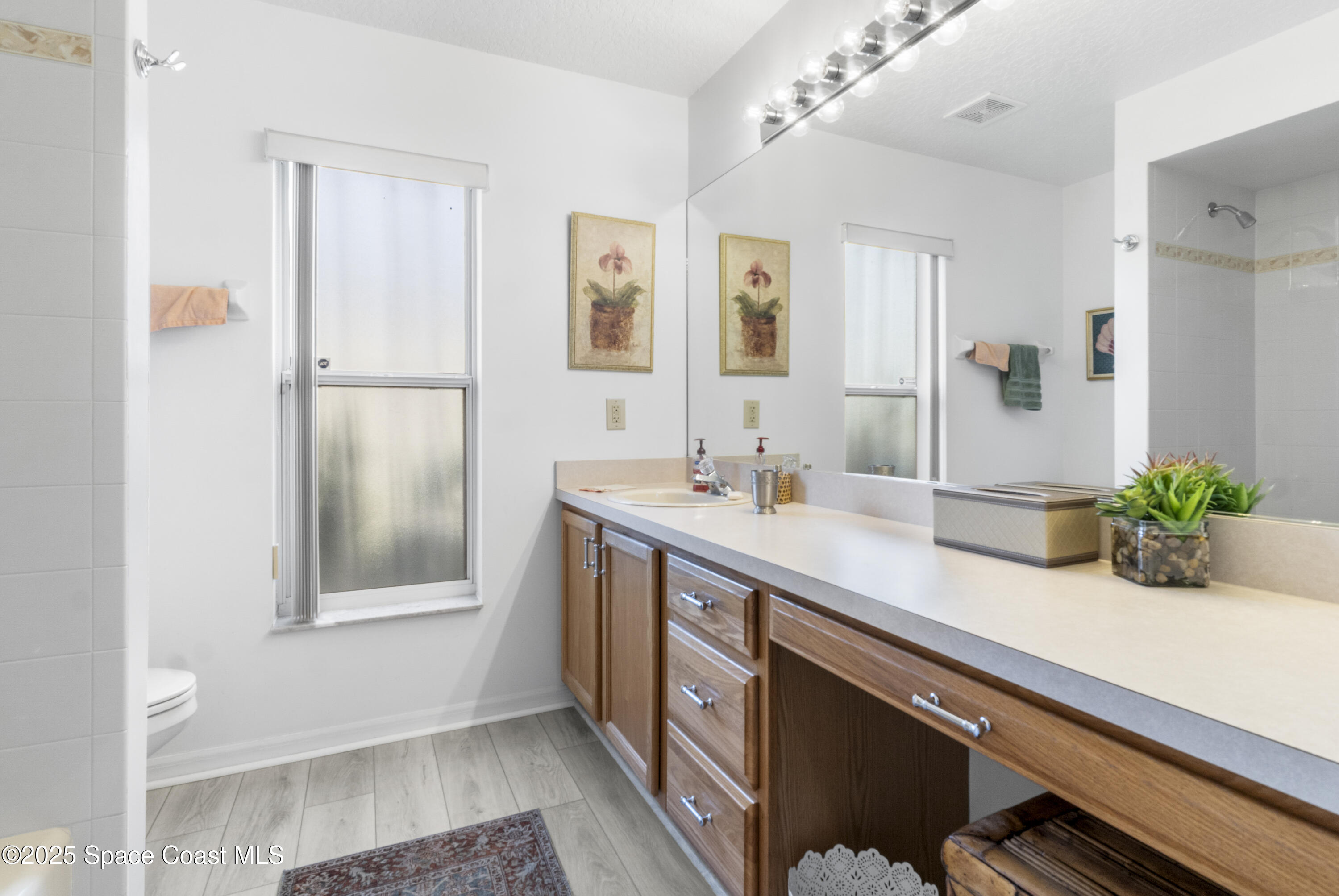 5155 3rd Manor Vero Beach, FL 32968 - Photo 21 of 29 a bathroom with a double vanity sink and a mirror