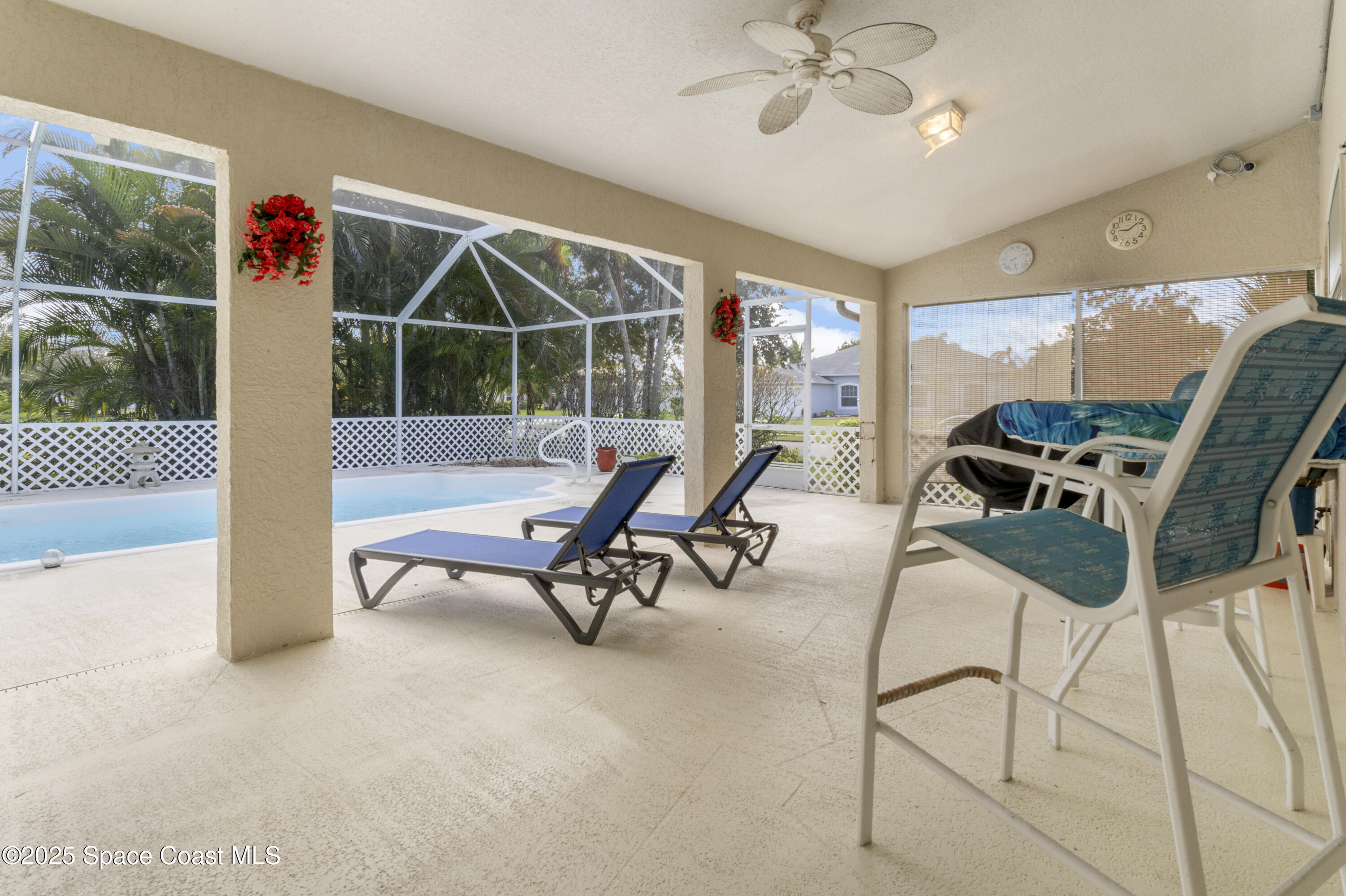 5155 3rd Manor Vero Beach, FL 32968 - Photo 26 of 29 a living room with furniture a floor to ceiling window and a flat screen tv