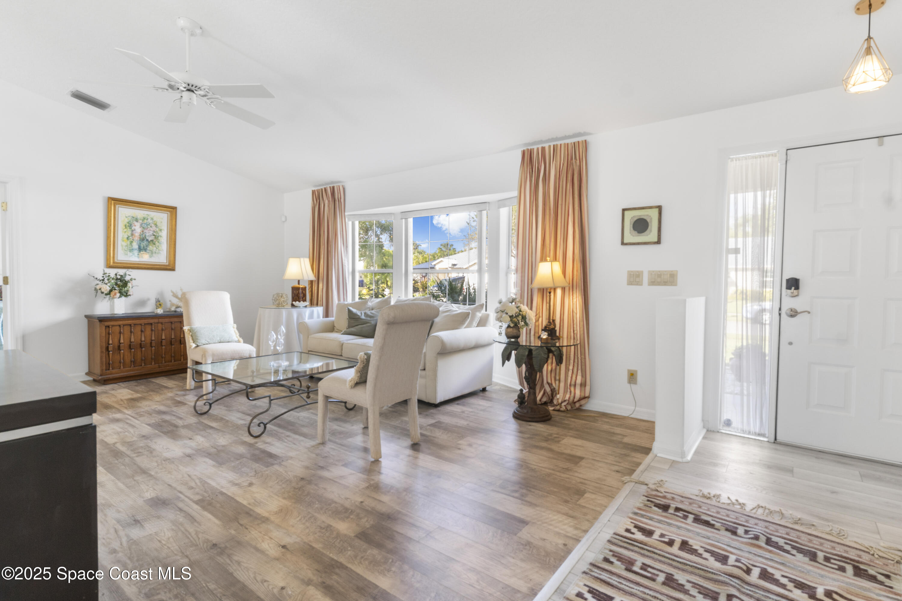 5155 3rd Manor Vero Beach, FL 32968 - Photo 6 of 29 a living room with furniture and a wooden floor