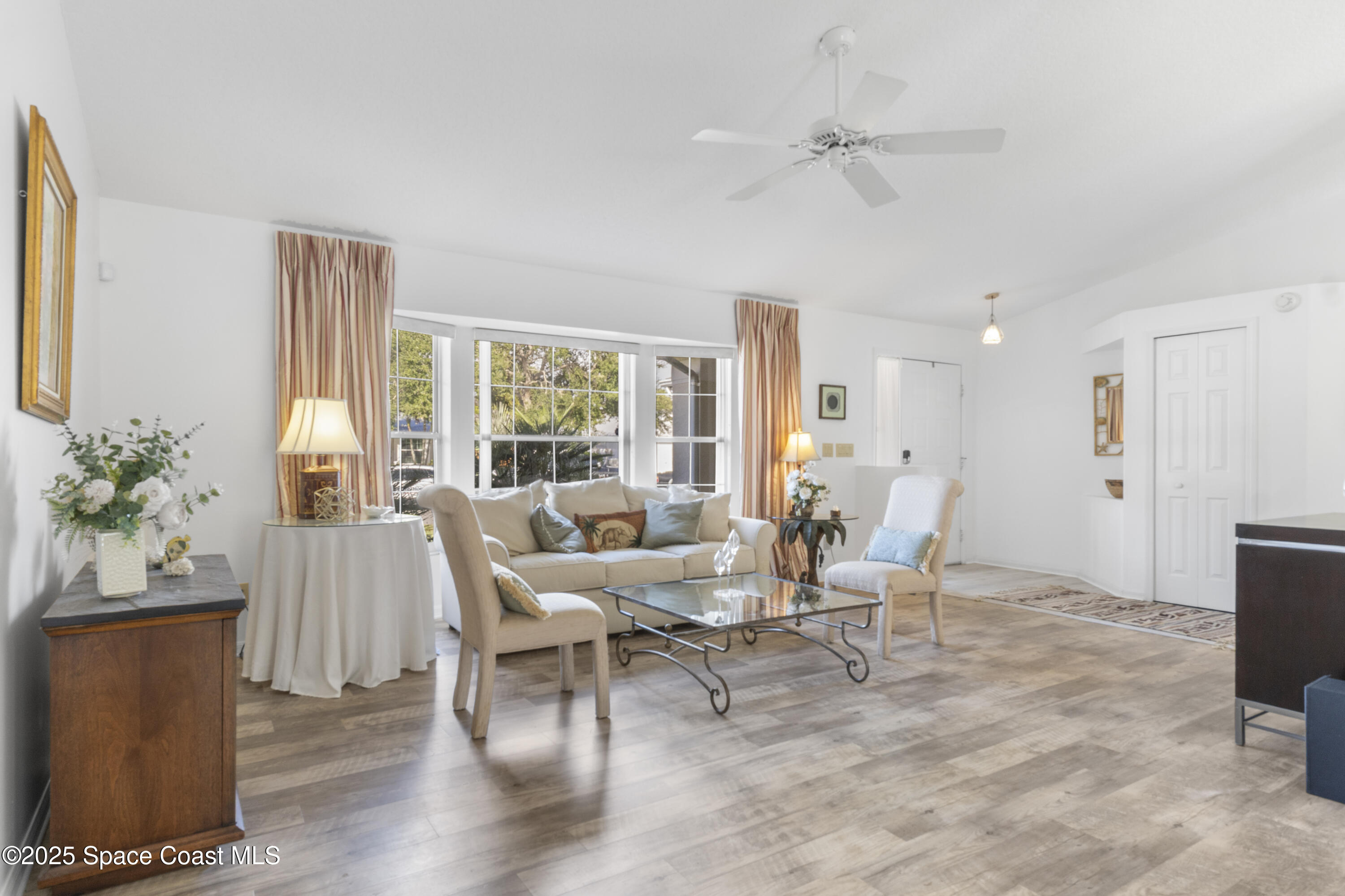 5155 3rd Manor Vero Beach, FL 32968 - Photo 7 of 29 a living room with furniture a window and a flat screen tv