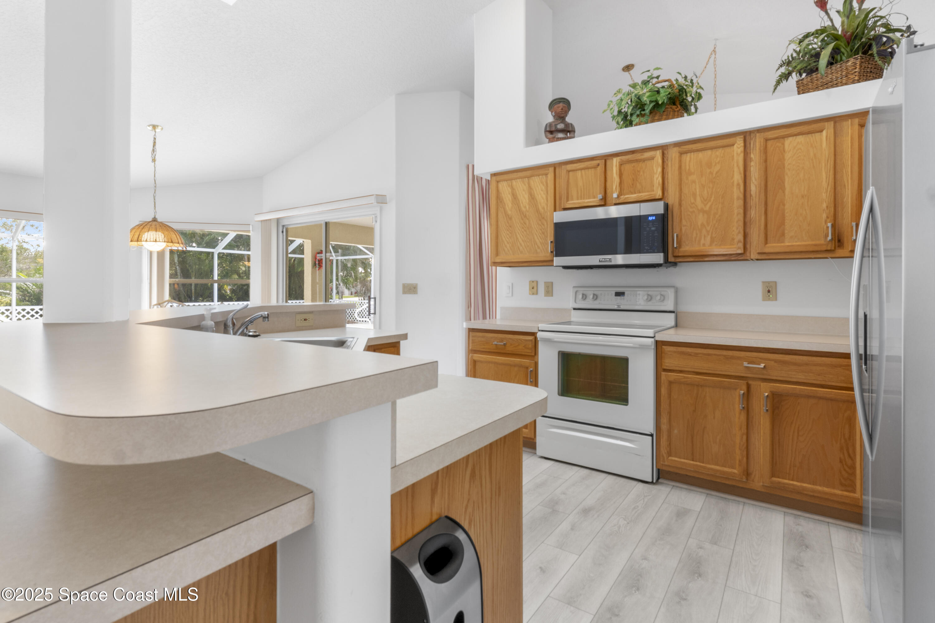 5155 3rd Manor Vero Beach, FL 32968 - Photo 10 of 29 a kitchen with a sink stove and microwave