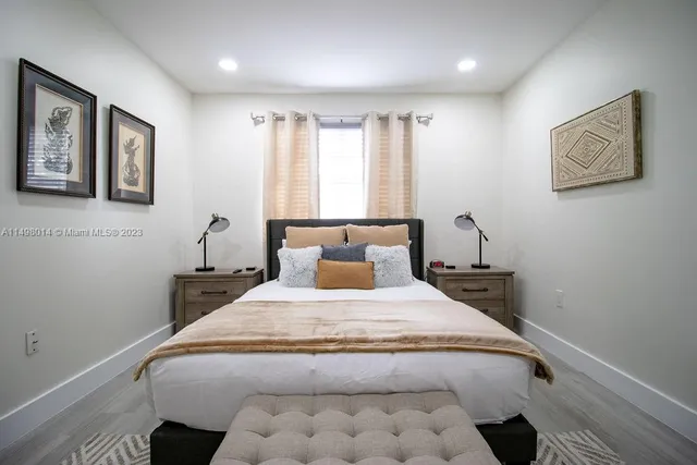 a bedroom with a large bed and a window