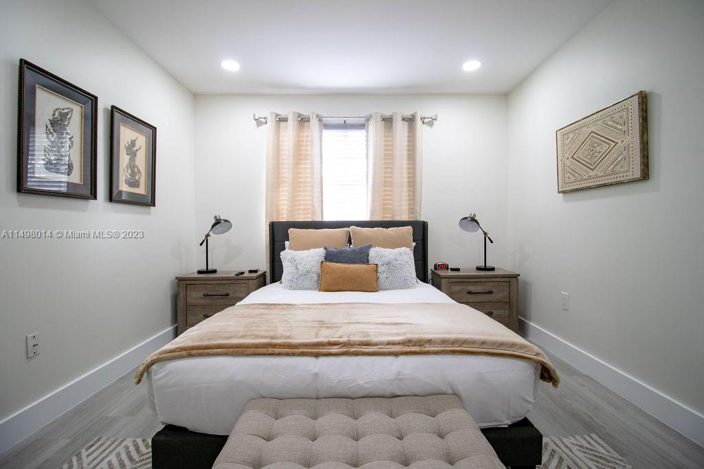 18706 Southwest 100th Avenue, Unit 18706 Cutler Bay, FL 33157 - Photo 11 of 20 a bedroom with a large bed and a window