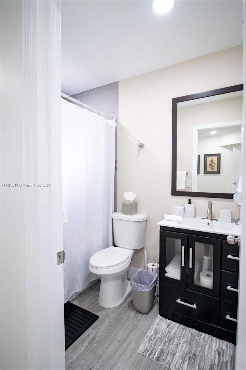 18706 Southwest 100th Avenue, Unit 18706 Cutler Bay, FL 33157 - Photo 16 of 20 a bathroom with a sink toilet a mirror and vanity