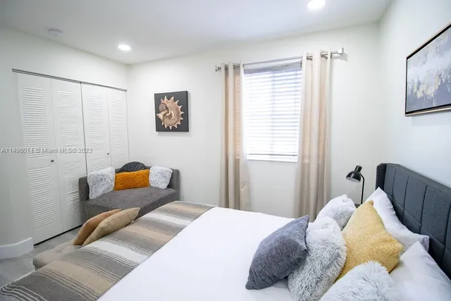 a bedroom with bed and window