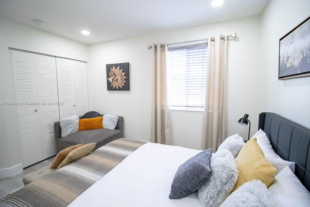 18706 Southwest 100th Avenue, Unit 18706 Cutler Bay, FL 33157 - Photo 17 of 20 a bedroom with bed and window