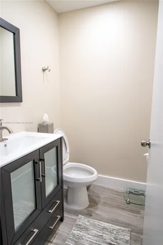a bathroom with a sink toilet and vanity