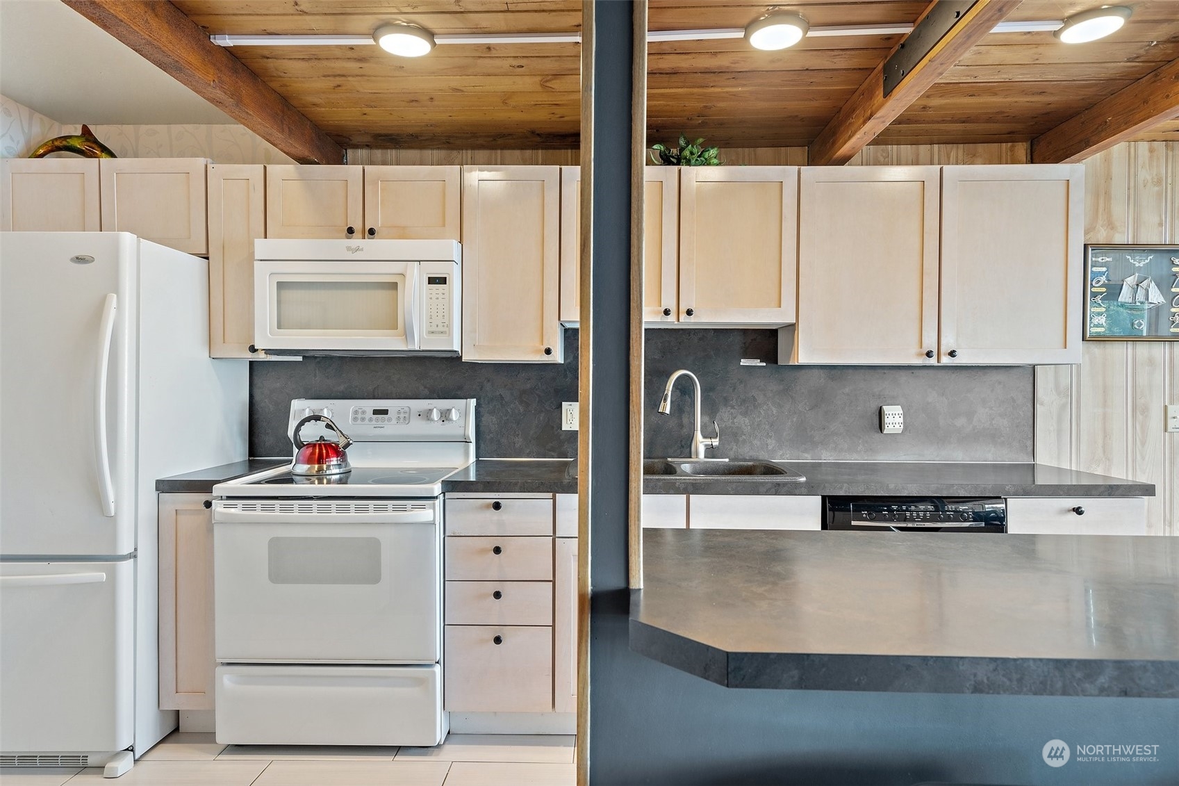 8371 Highway 106 Union, WA 98592 - Photo 6 of 29 a kitchen with granite countertop a white cabinets and white appliances