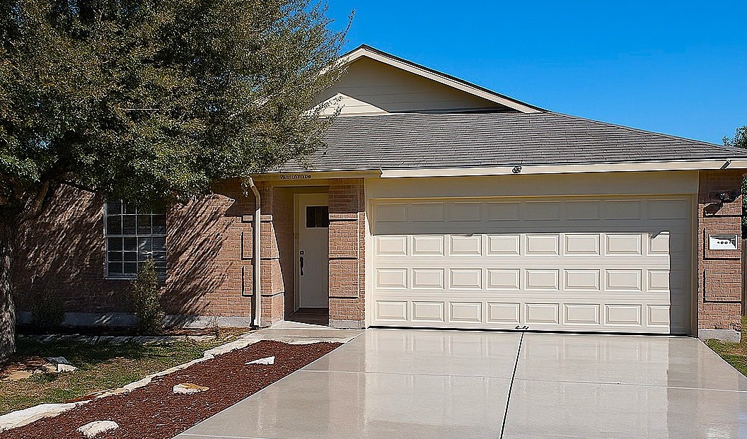 1004 Bluff Meadow Cove Georgetown, TX 78626 - Photo 1 of 26 a front view of a house with a garage