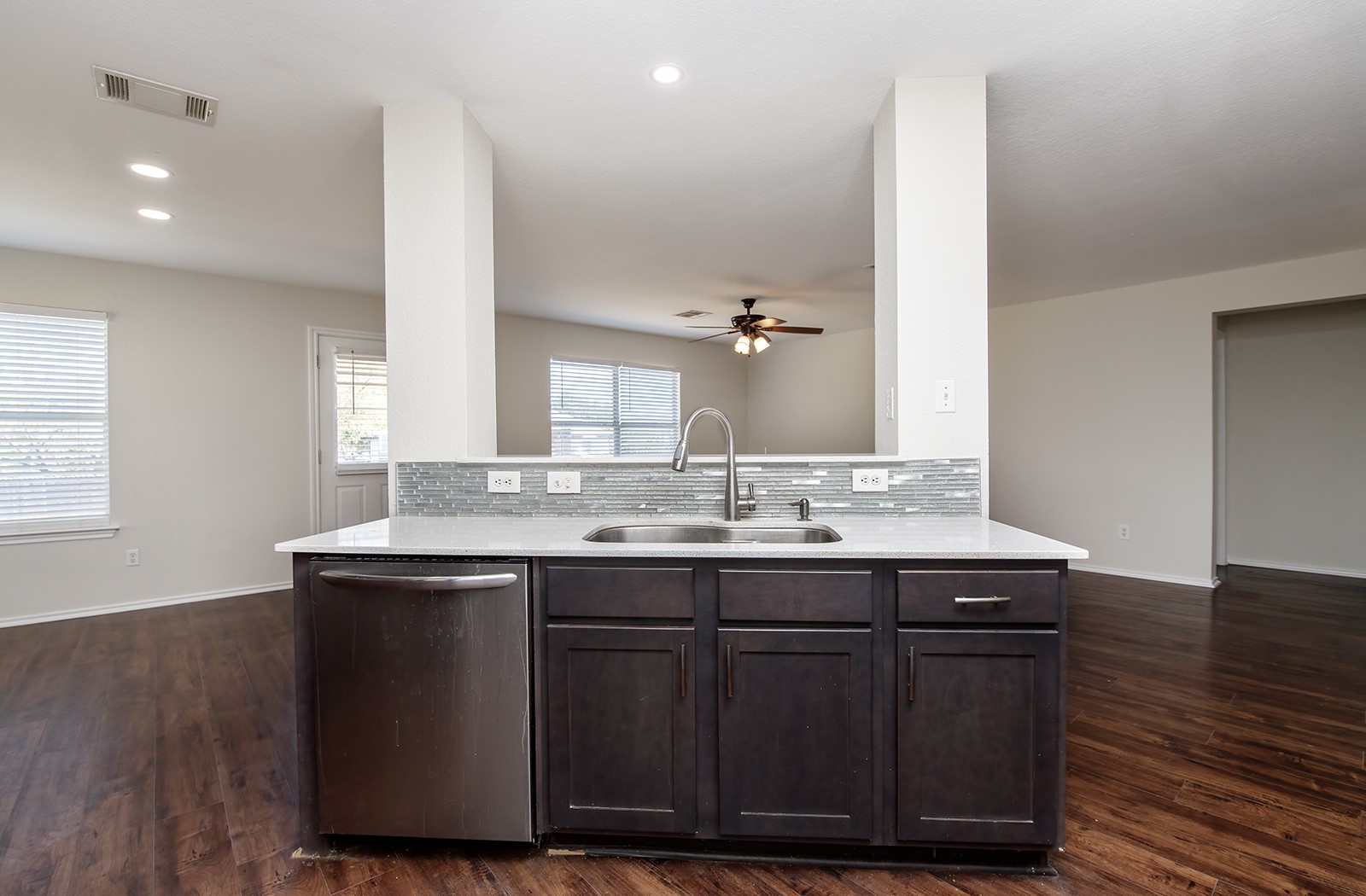 1004 Bluff Meadow Cove Georgetown, TX 78626 - Photo 7 of 26 a kitchen with a sink cabinets and wooden floor