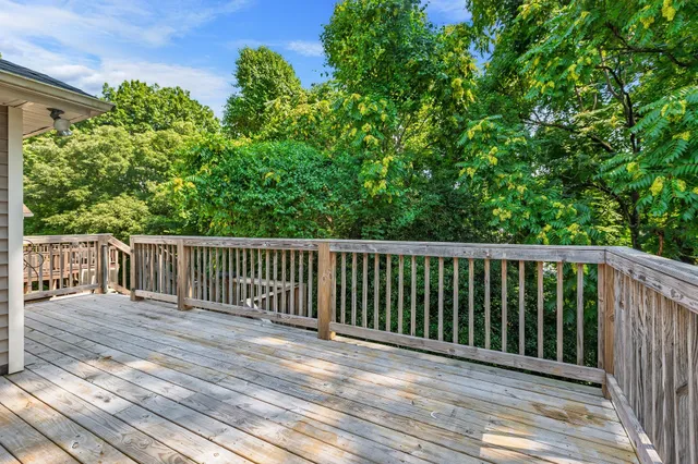 a view of a house with backyard and trees