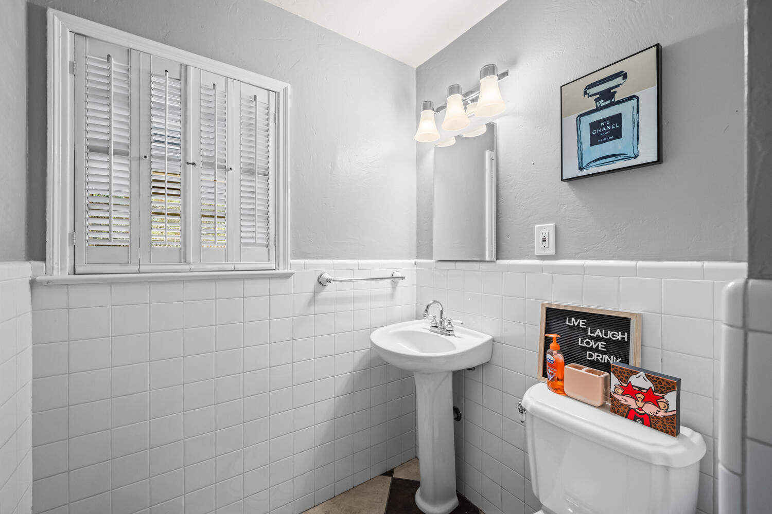 3206 56th Street Lubbock, TX 79413 - Photo 19 of 32 a bathroom with a sink toilet and a mirror