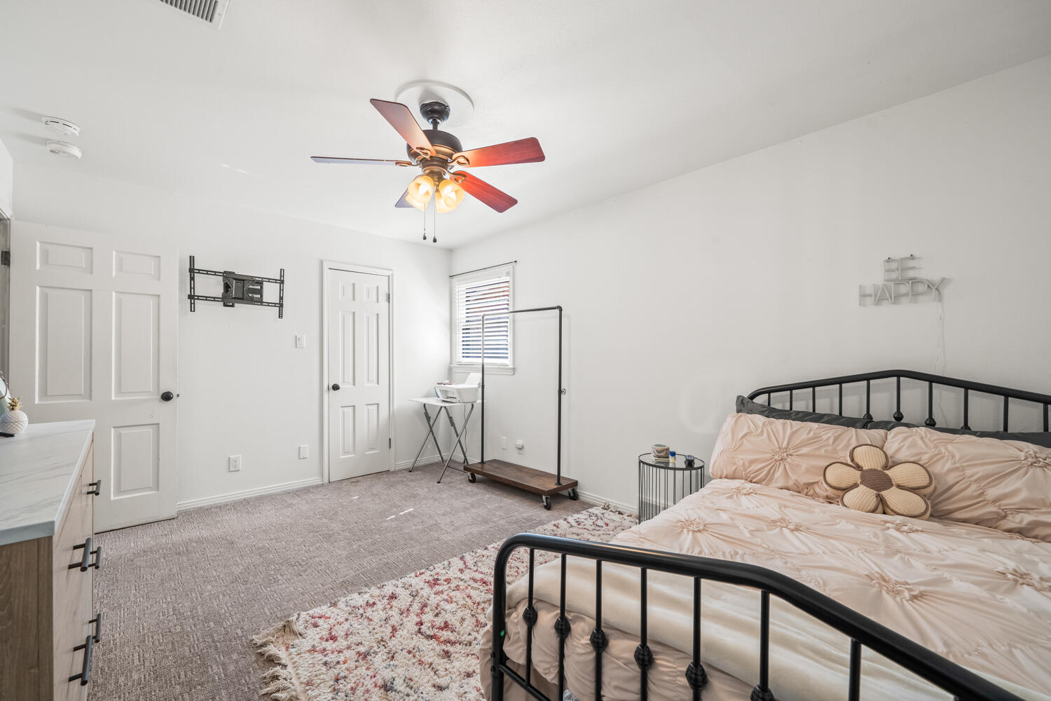 3206 56th Street Lubbock, TX 79413 - Photo 20 of 32 a bedroom with a bed and a chandelier