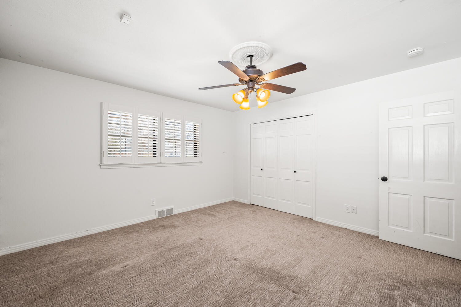 3206 56th Street Lubbock, TX 79413 - Photo 21 of 32 an empty room with a window and a ceiling fan