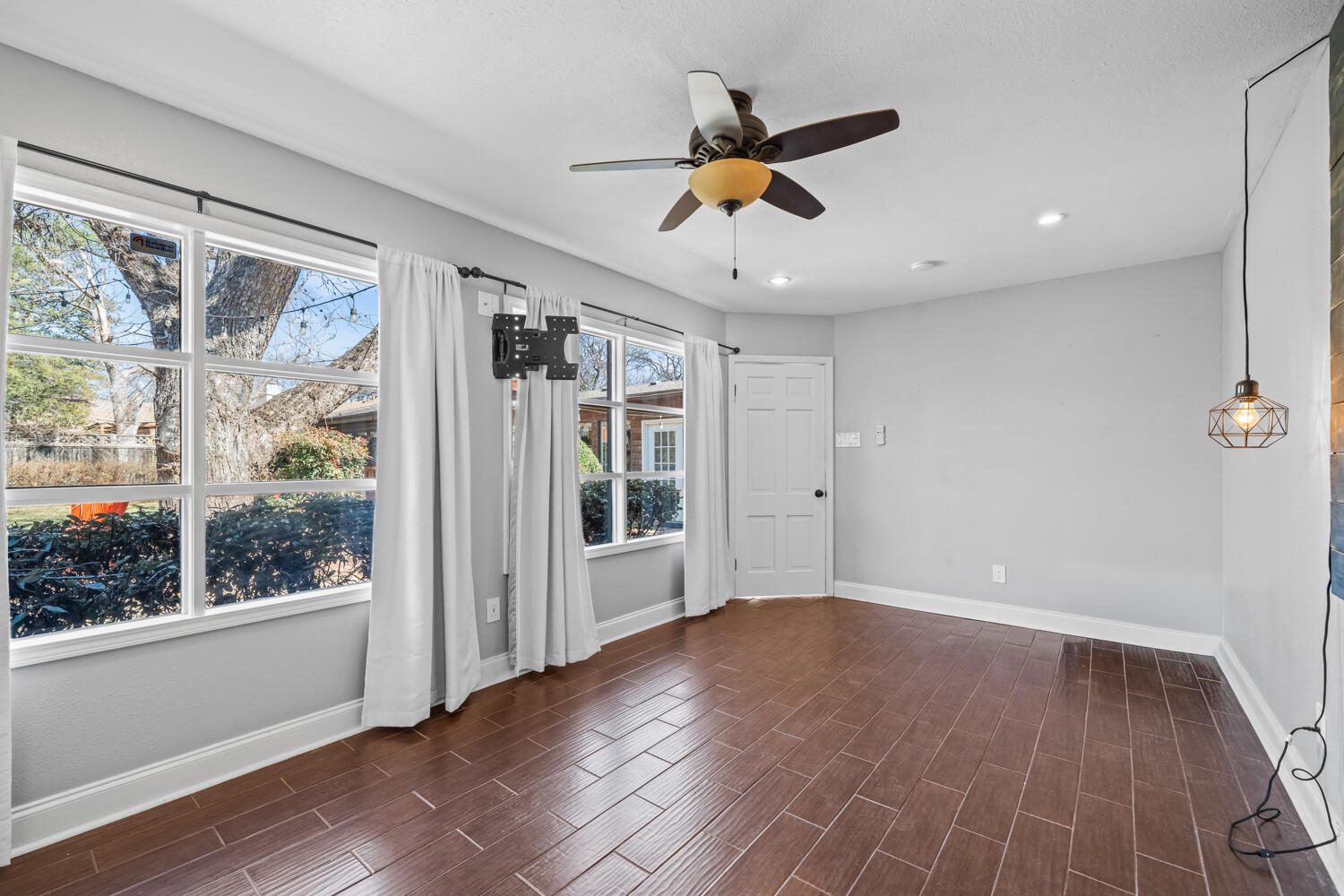 3206 56th Street Lubbock, TX 79413 - Photo 28 of 32 a view of an empty room with wooden floor and a window