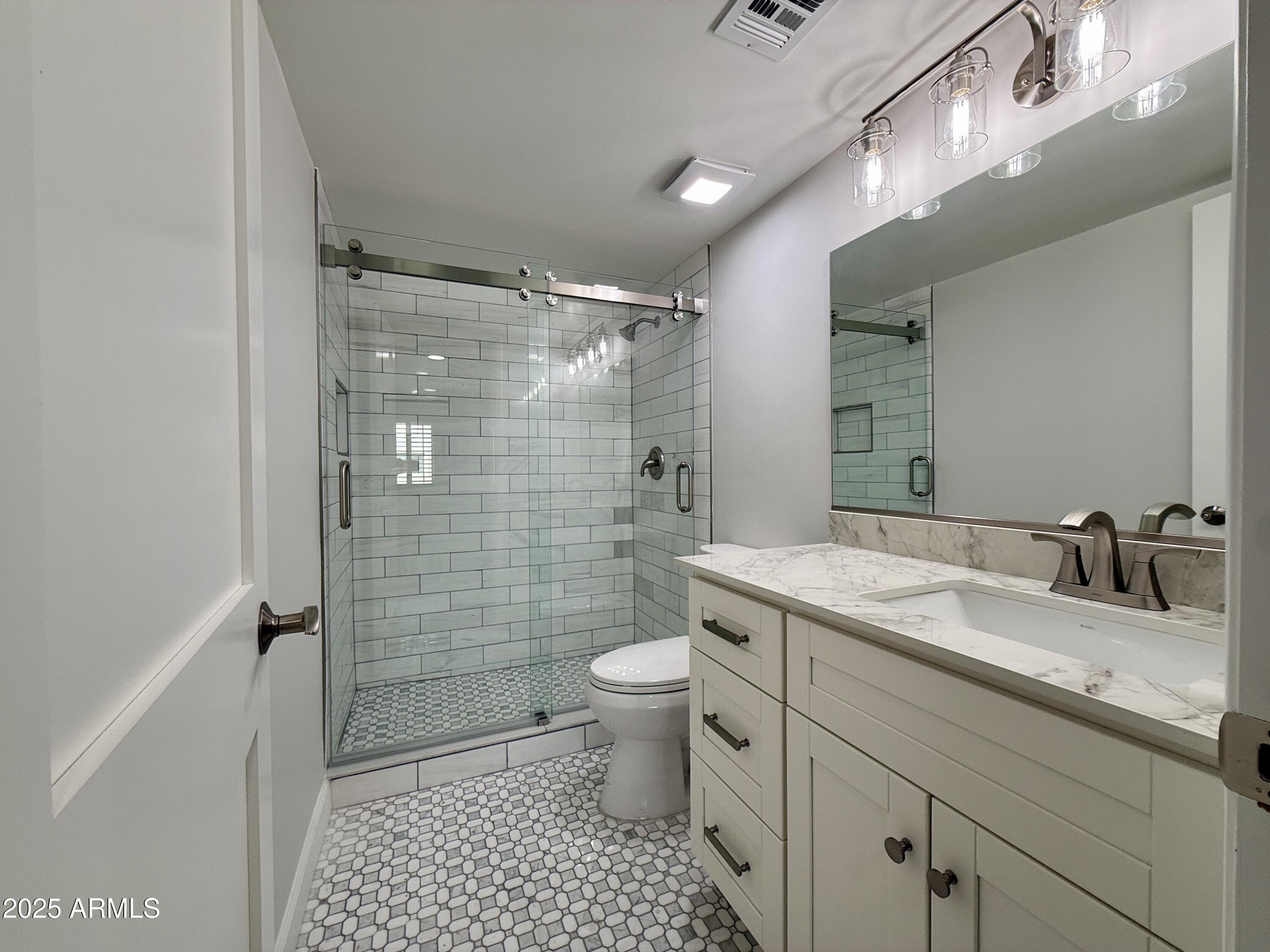 7930 East Camelback Road, Unit 709 Scottsdale, AZ 85251 - Photo 22 of 41 a bathroom with a granite countertop sink toilet and shower