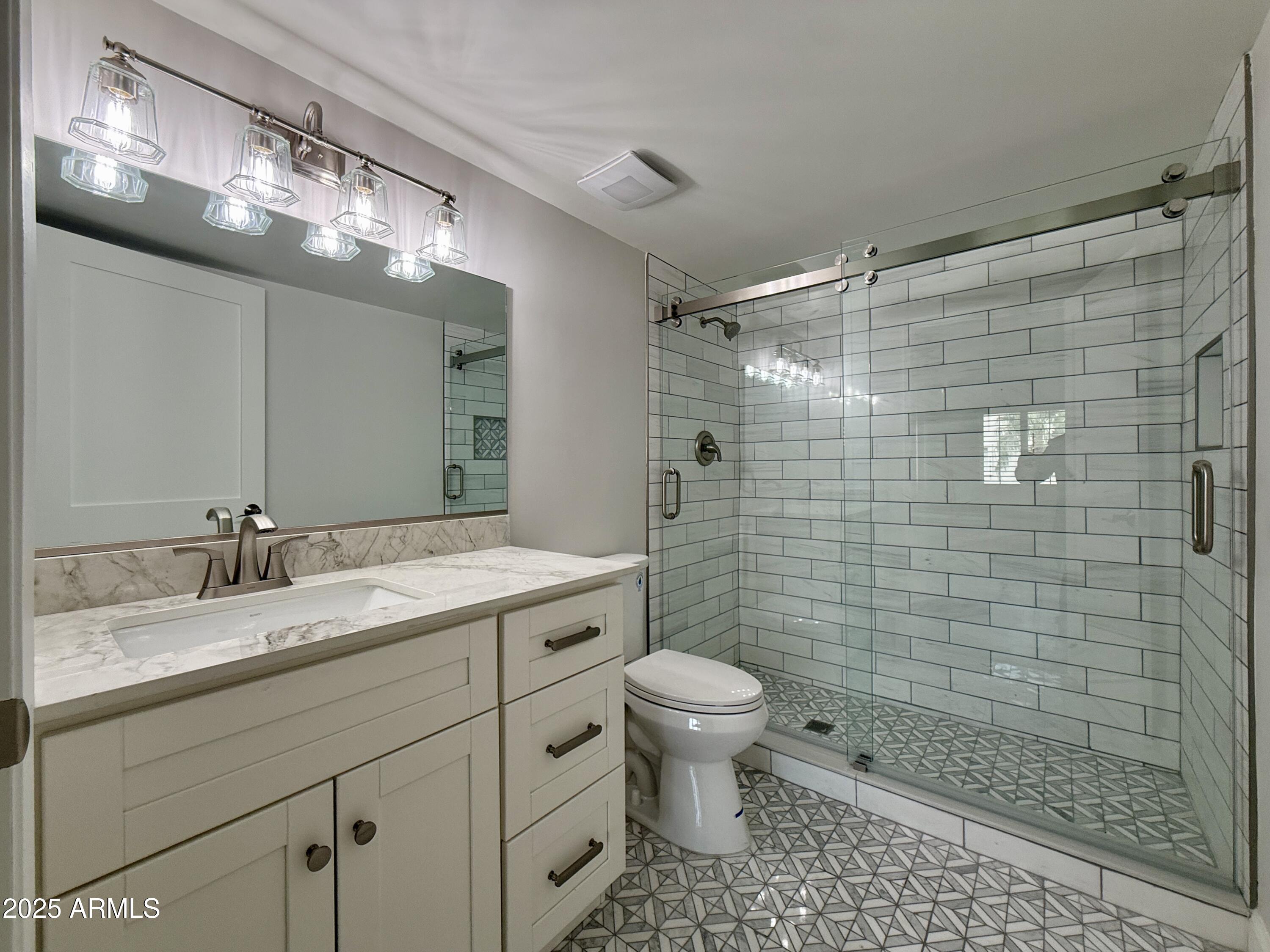 7930 East Camelback Road, Unit 709 Scottsdale, AZ 85251 - Photo 29 of 41 a bathroom with a sink a toilet and shower