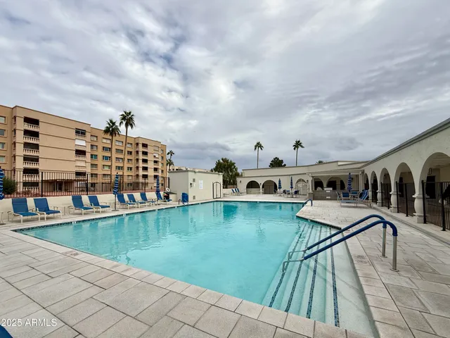 a living room with lots of furniture and kitchen view