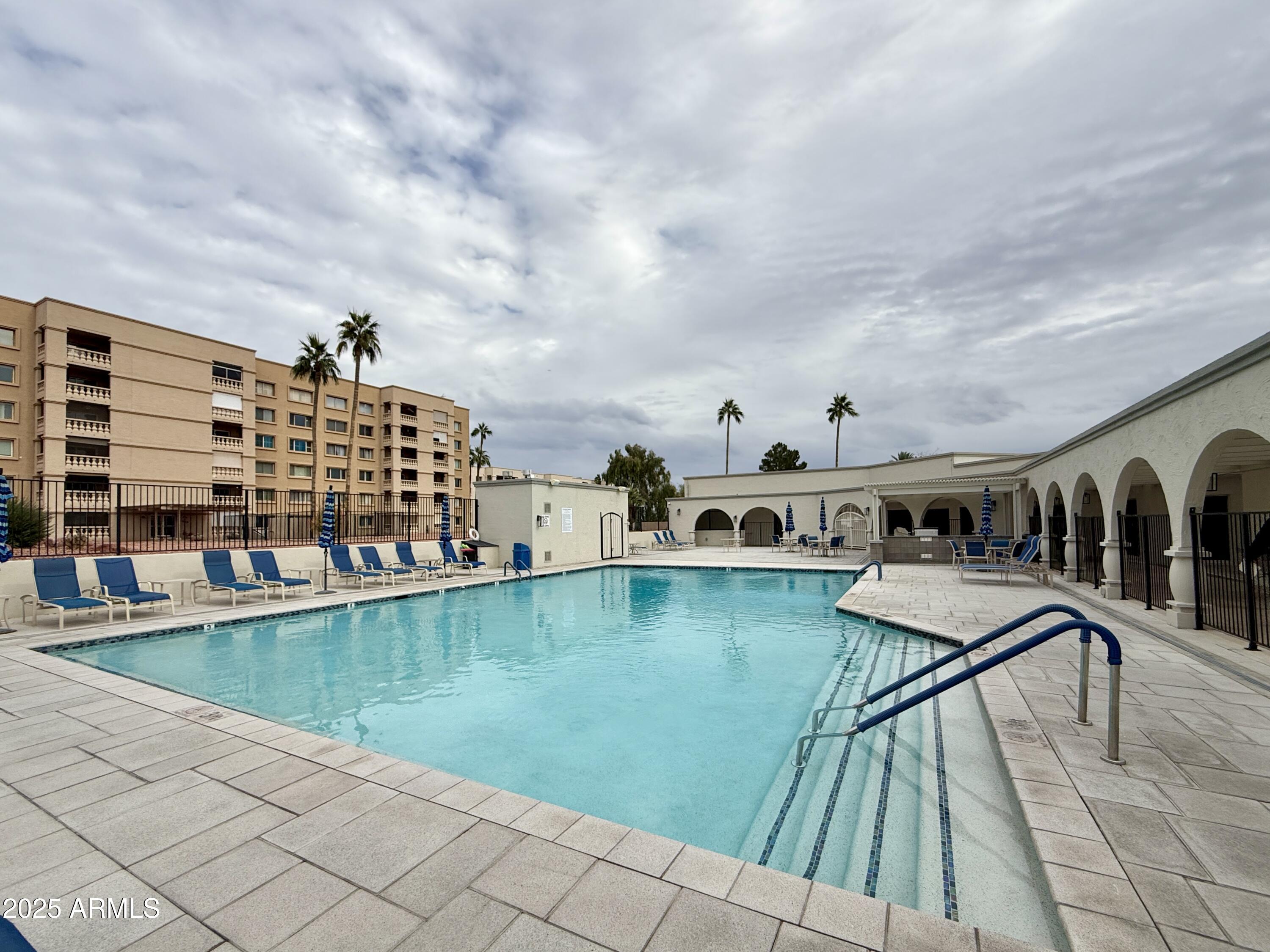7930 East Camelback Road, Unit 709 Scottsdale, AZ 85251 - Photo 36 of 41 a view of swimming pool with outdoor seating and barbeque oven