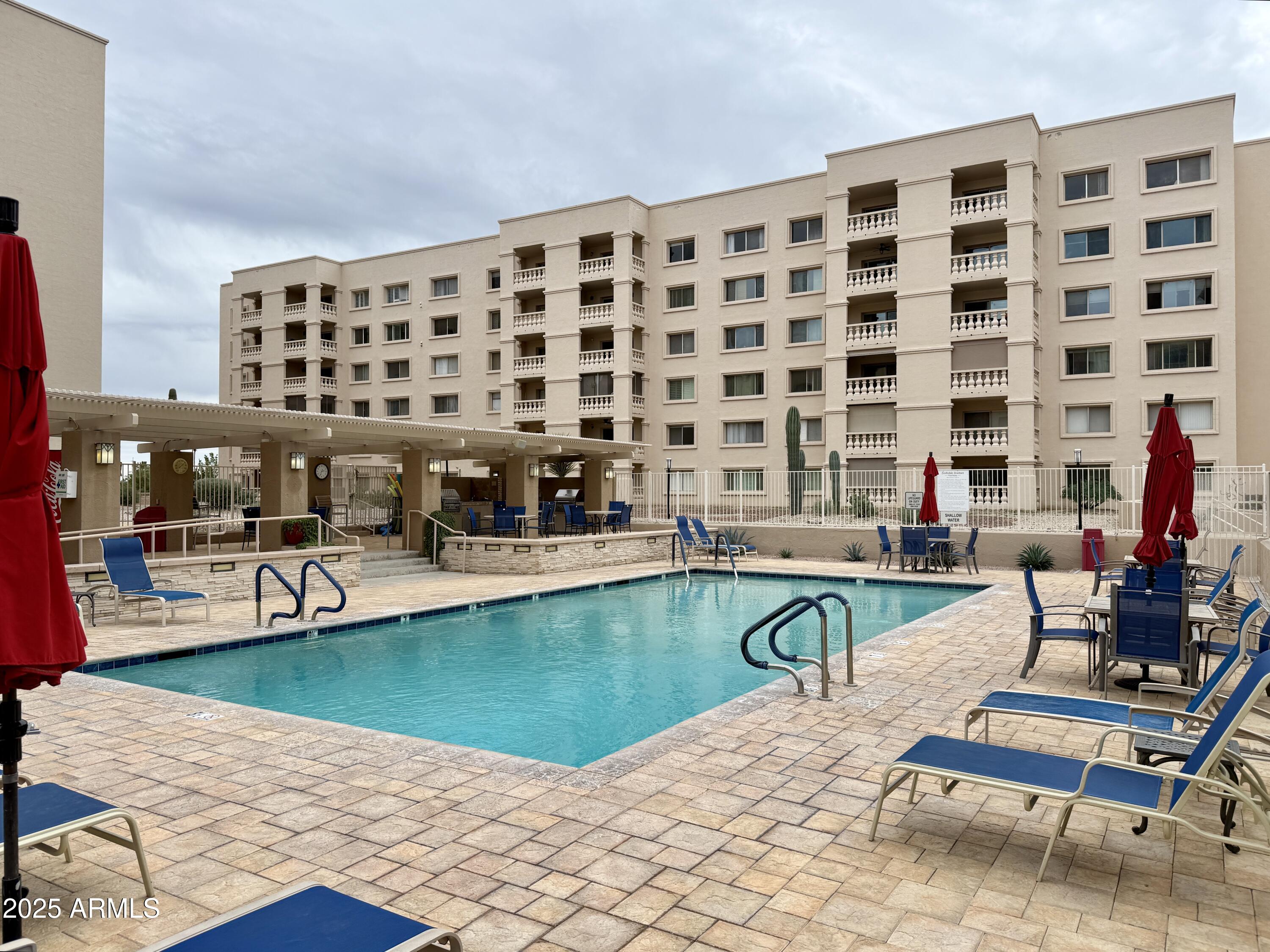 7930 East Camelback Road, Unit 709 Scottsdale, AZ 85251 - Photo 41 of 41 a view of a swimming pool with outdoor seating