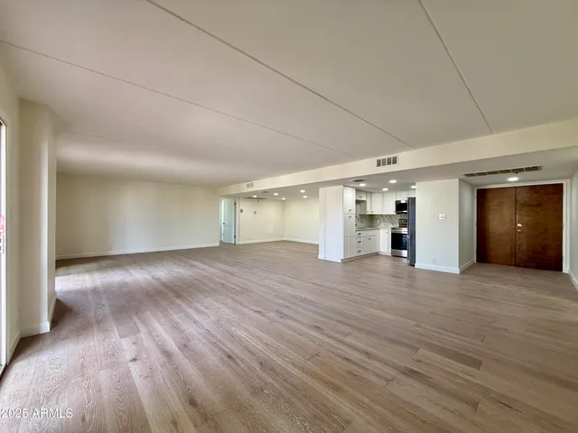 a kitchen with granite countertop a refrigerator and a stove top oven