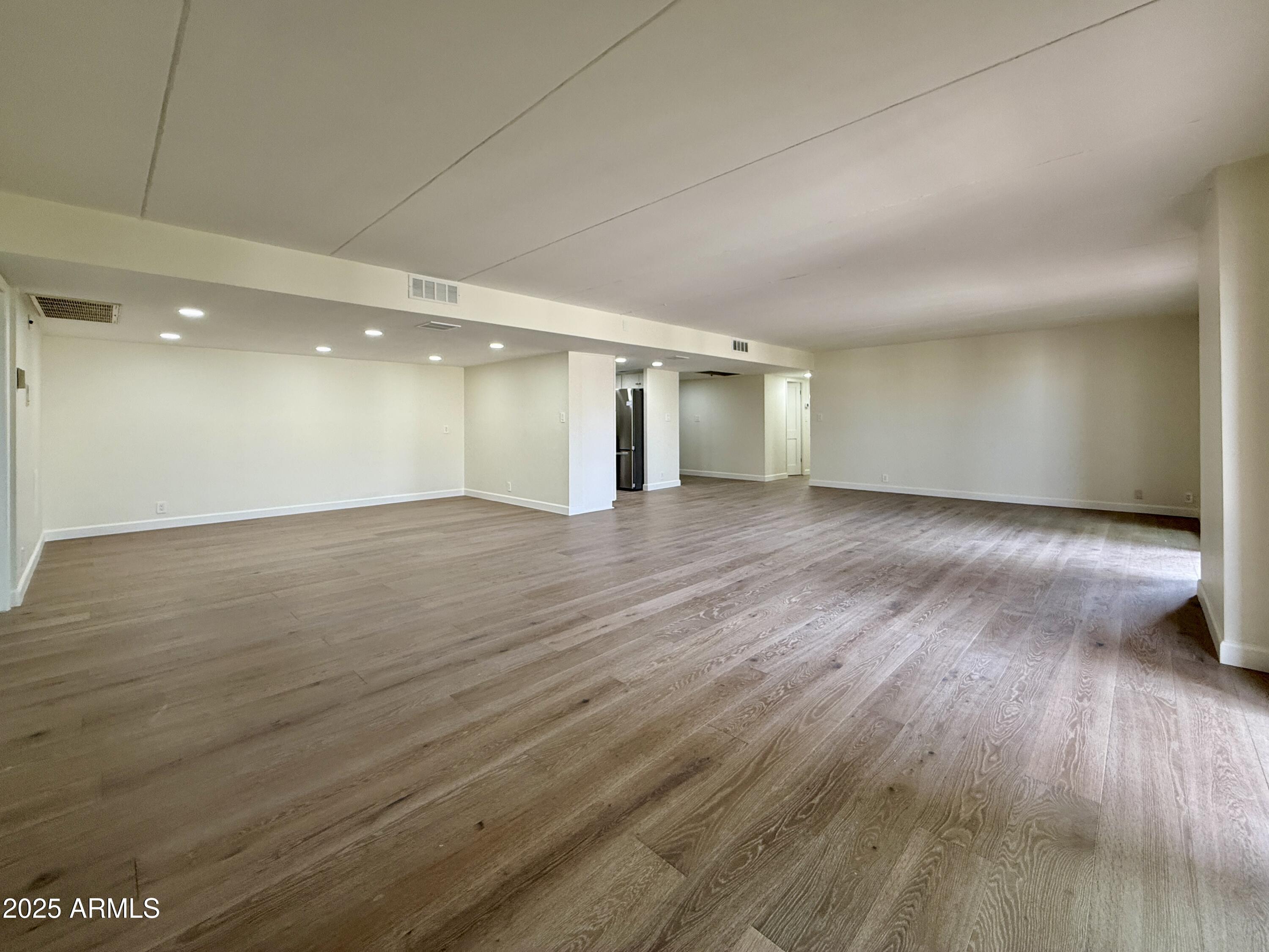 7930 East Camelback Road, Unit 709 Scottsdale, AZ 85251 - Photo 9 of 41 a view of a big room with wooden floor and windows
