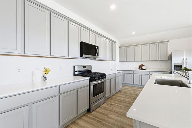 a kitchen with white cabinets and white appliances