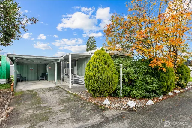 a view of a house with a small yard and potted plants