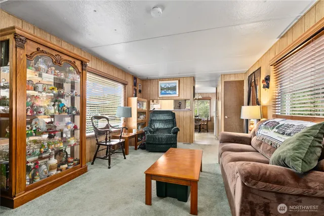 a living room with furniture a fireplace and a large window