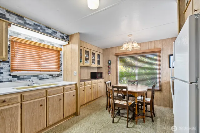 a kitchen with kitchen island granite countertop a sink dining table and chairs