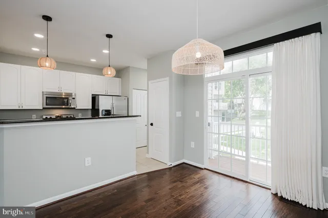 a kitchen with stainless steel appliances granite countertop a refrigerator a stove a sink and a refrigerator