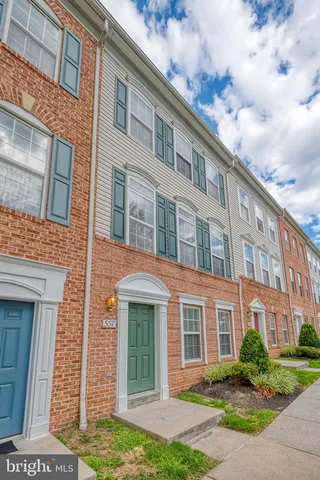 front view of a brick house with a yard