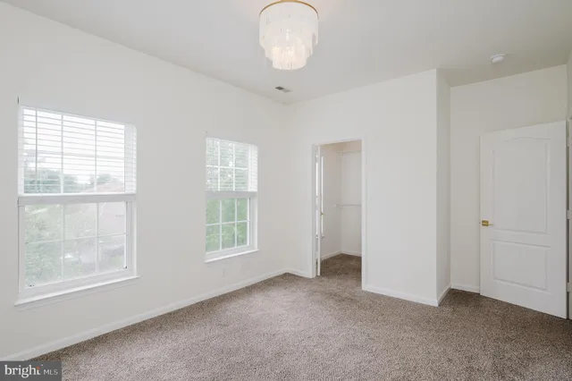 a large kitchen with a large window and stainless steel appliances