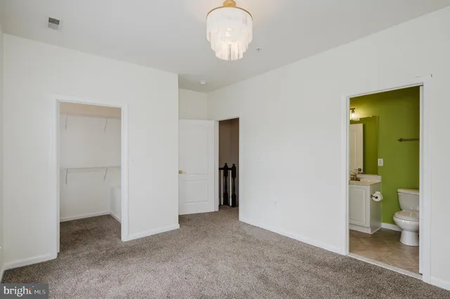 a view of living room with furniture and a chandelier