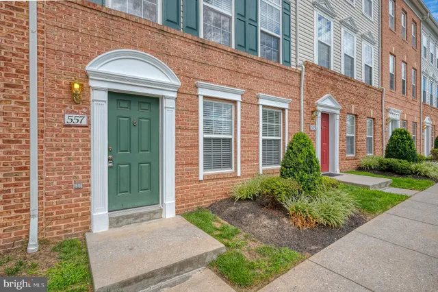 front view of a brick house with a small yard