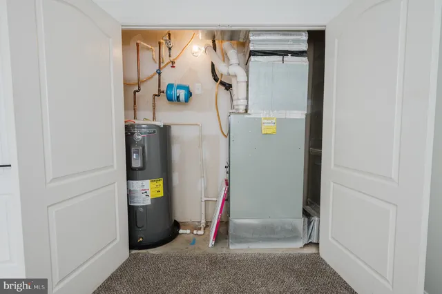 a view of a house with a big yard potted plants and large tree