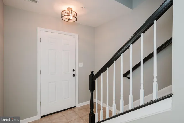 an entryway with wooden floor and stairs