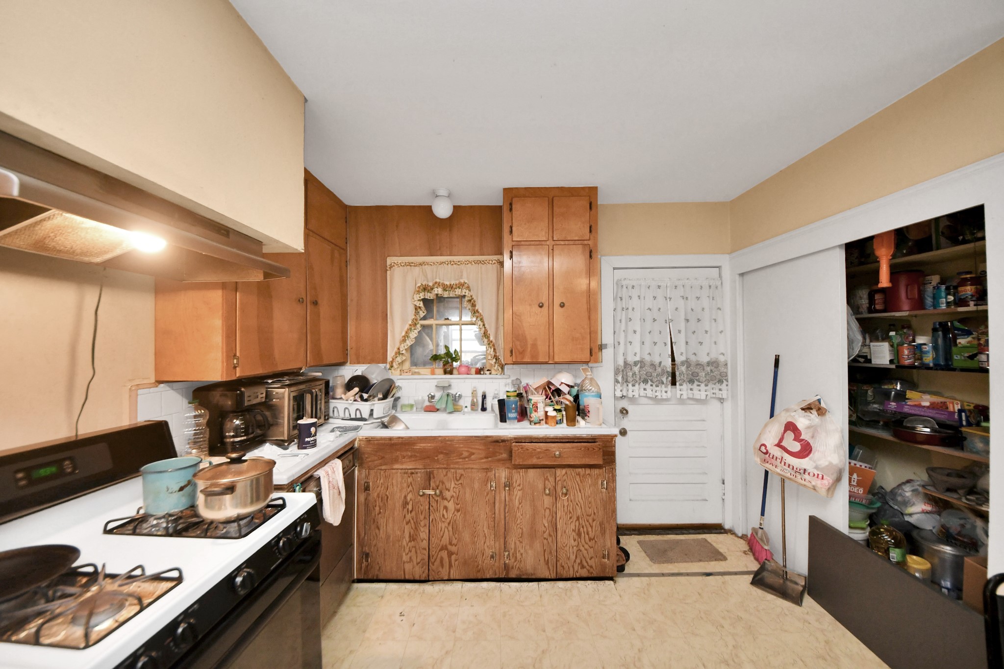 5134 Leeland Street Houston, TX 77023 - Photo 14 of 28 a kitchen with a stove and a refrigerator